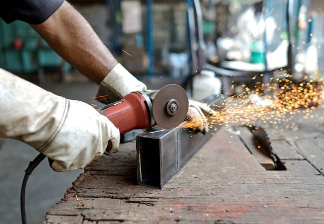 man cut metal with tool have spark light