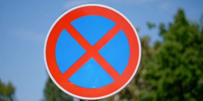 Blue Road Sign With Red Cross